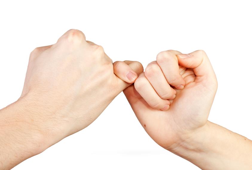 Man and woman making a pinky promise. Hands isolated on white background.